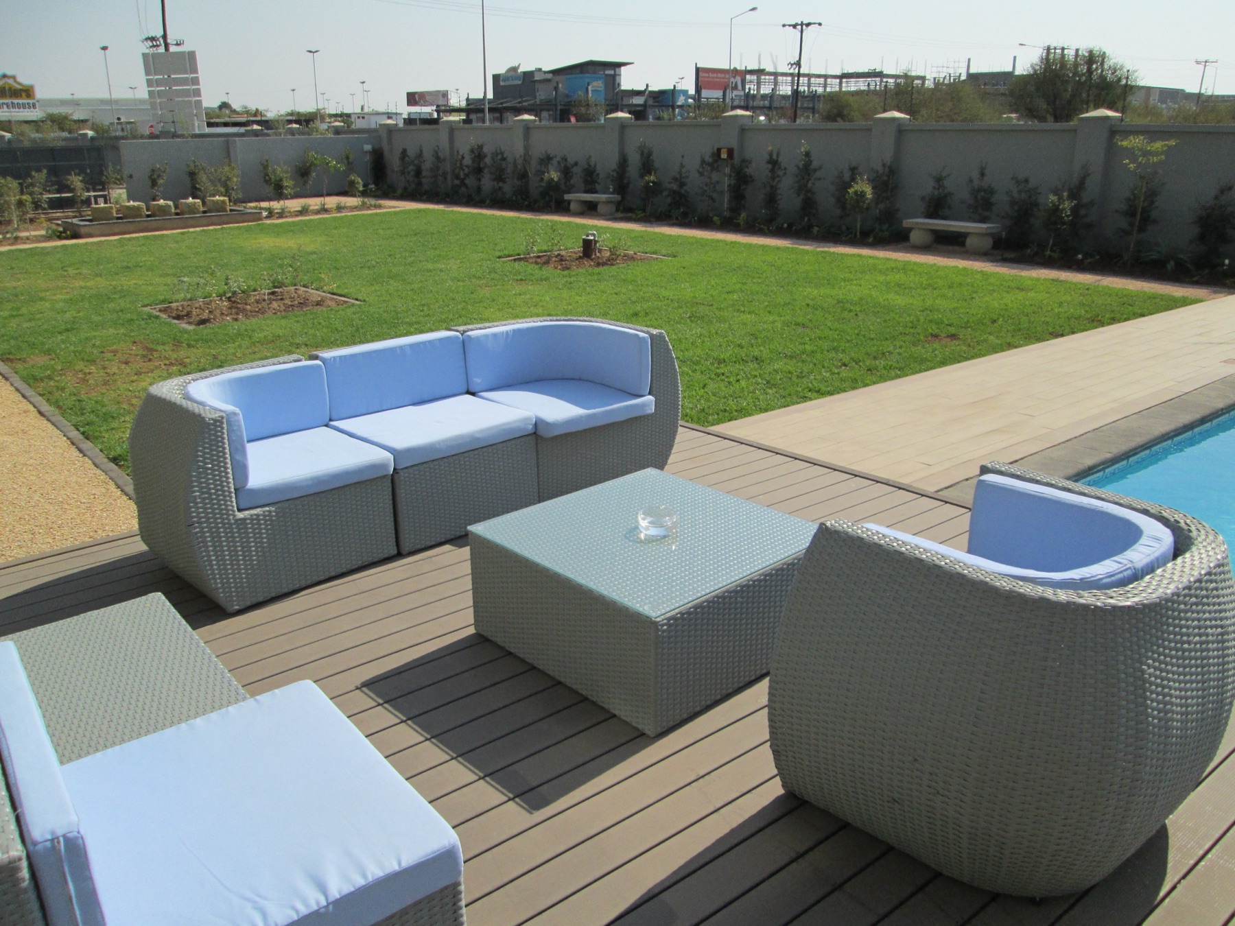 Lush greenery and gardens surrounding the Aquarian Tide Hotel pool